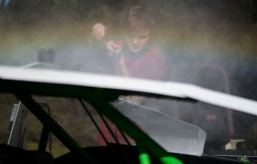 Louie Lovelace washes dirt from the previous night's races